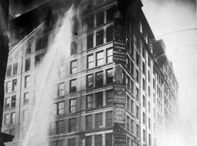 Water from fire hoses spraying the top floors of the Asch Building